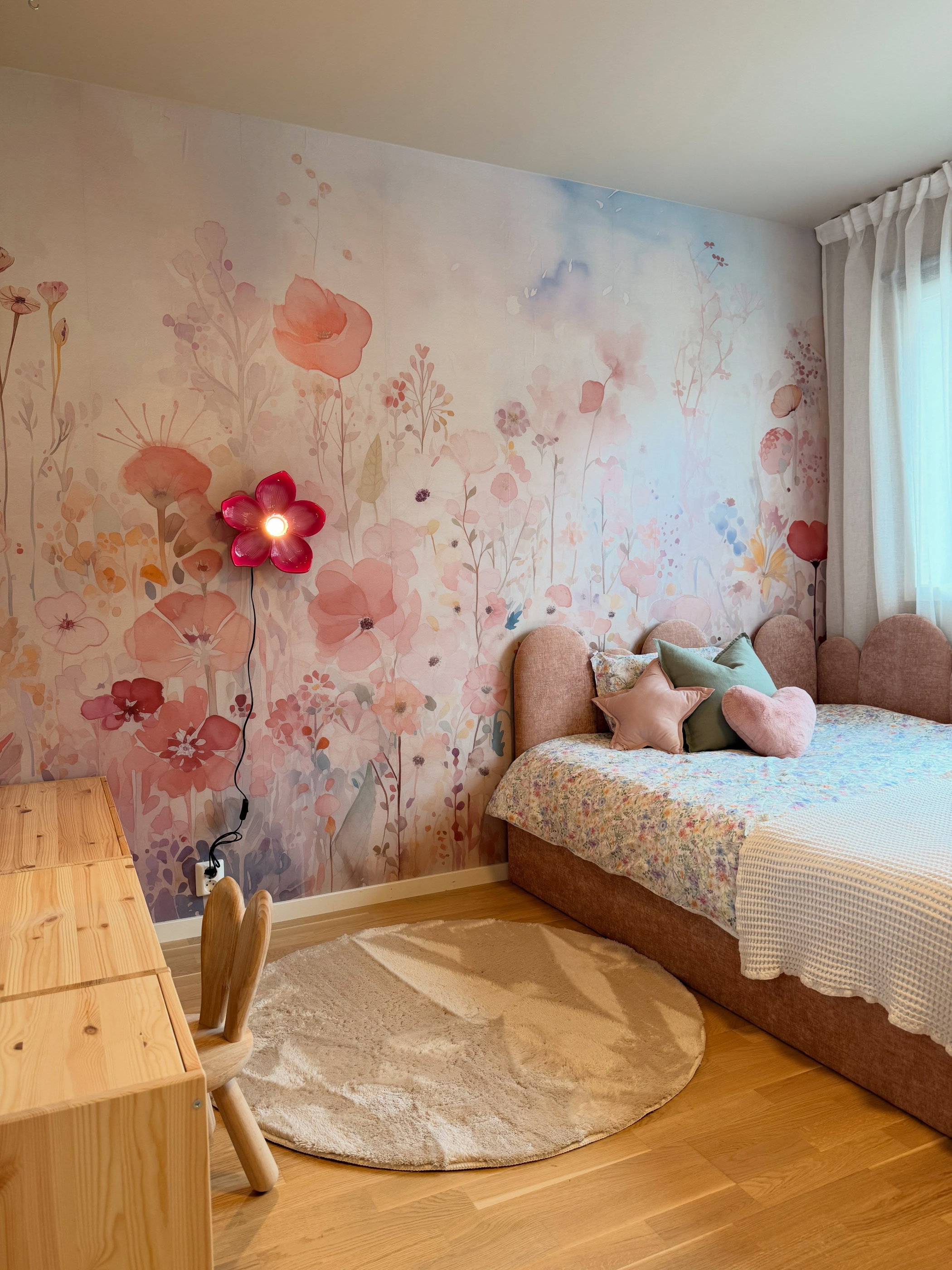 Bedroom with pink flower wallpaper, pink bed, and wood furniture.