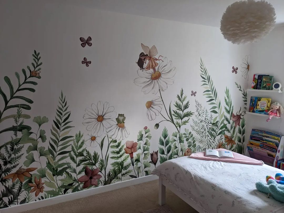 Child's bedroom with floral wall decals, white bed, and bookshelves.