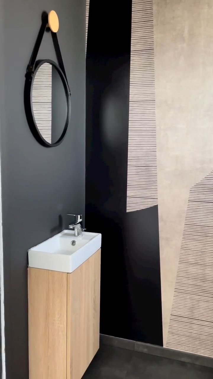 Bathroom corner with white sink, chrome faucet, and soap dispenser.