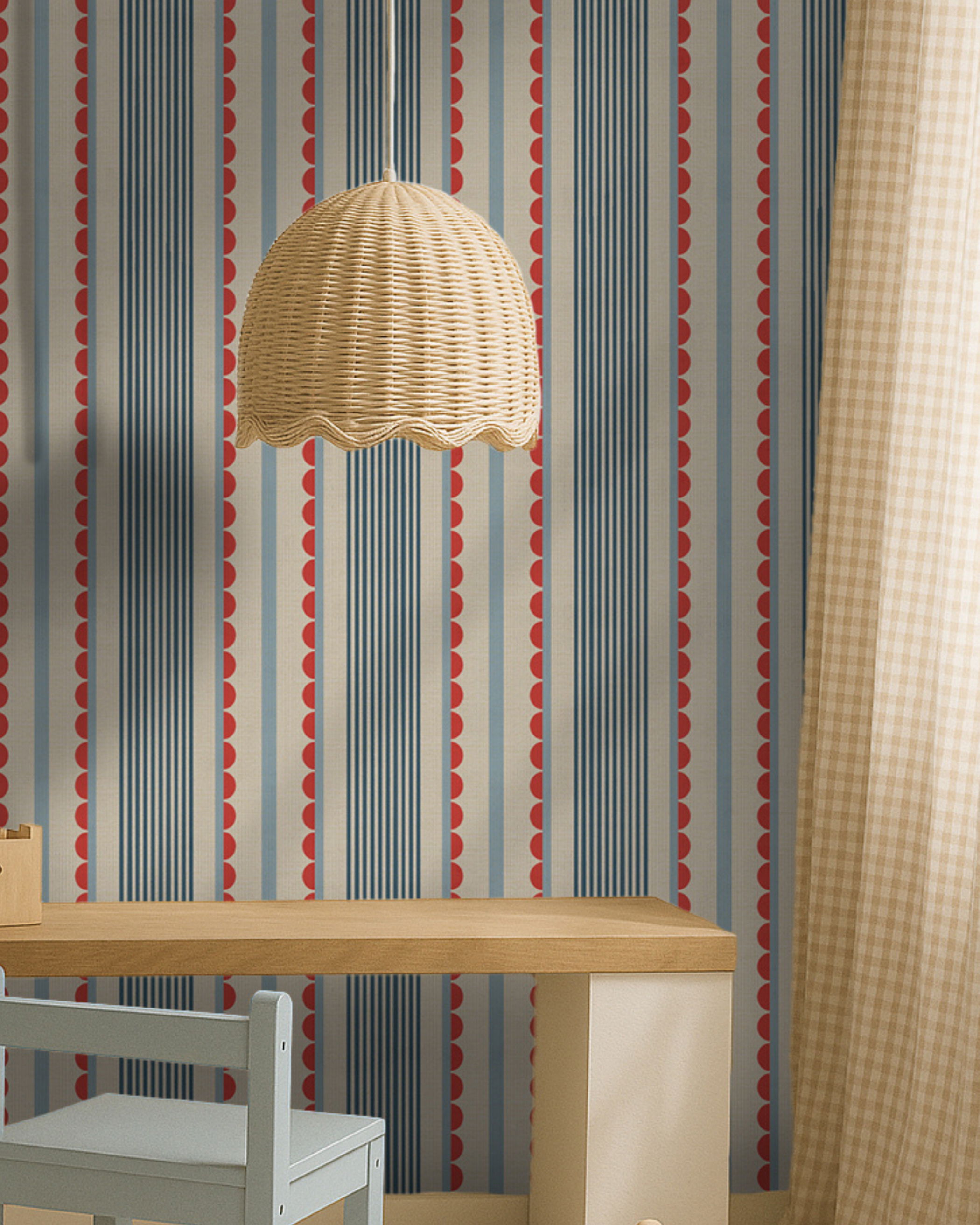 Interior with striped wallpaper, wicker pendant light, desk, and chair.