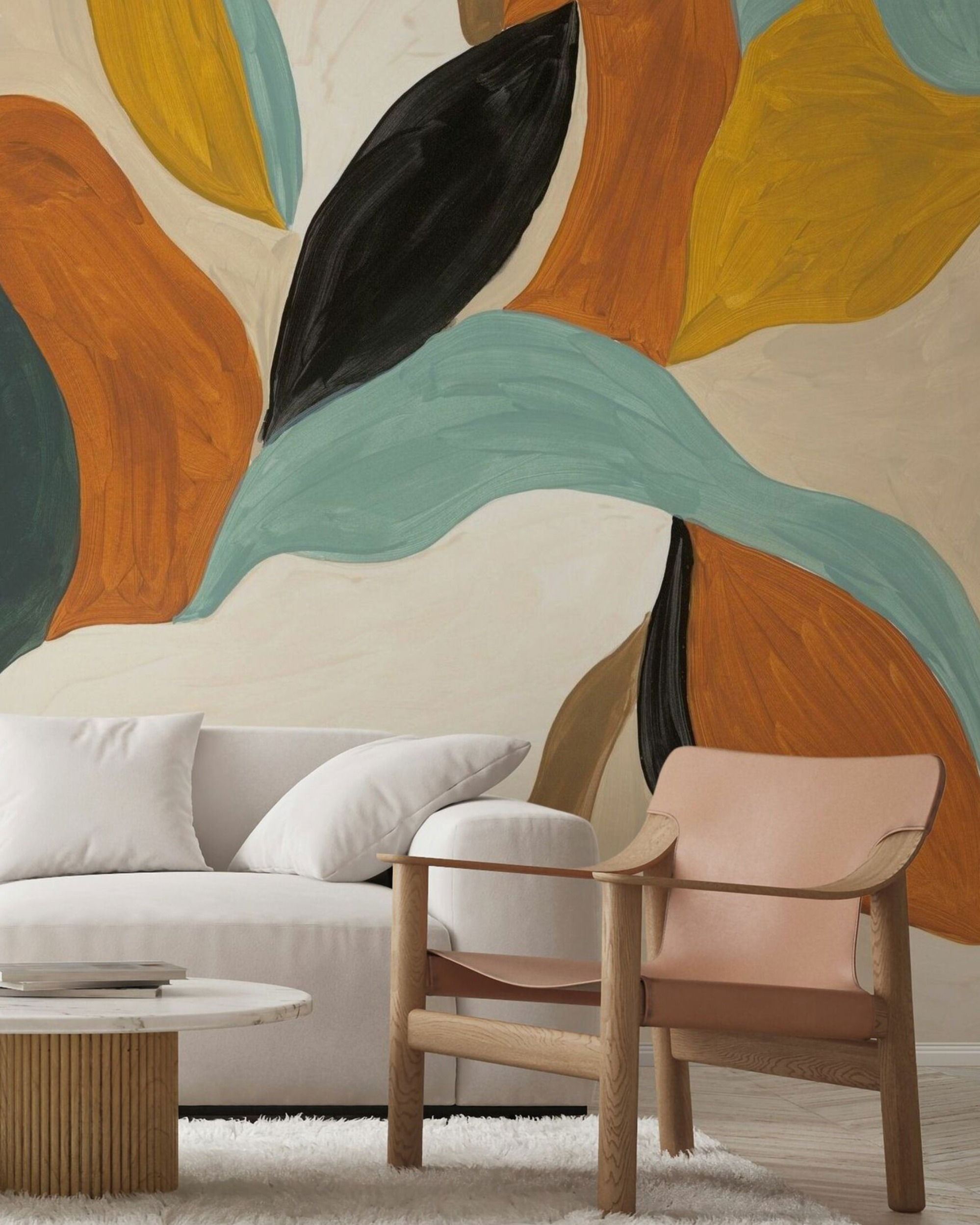 Living room with abstract leaf-patterned wallpaper, white sofa, and light wood and leather chair.