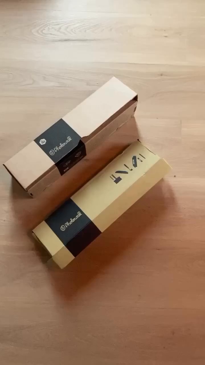 Two Photowall boxes on a wood floor.