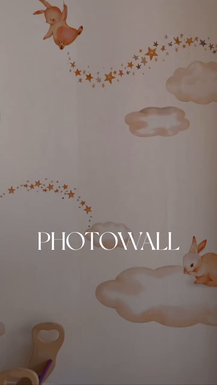 Watercolor-style wall art with rabbits, clouds, and stars.