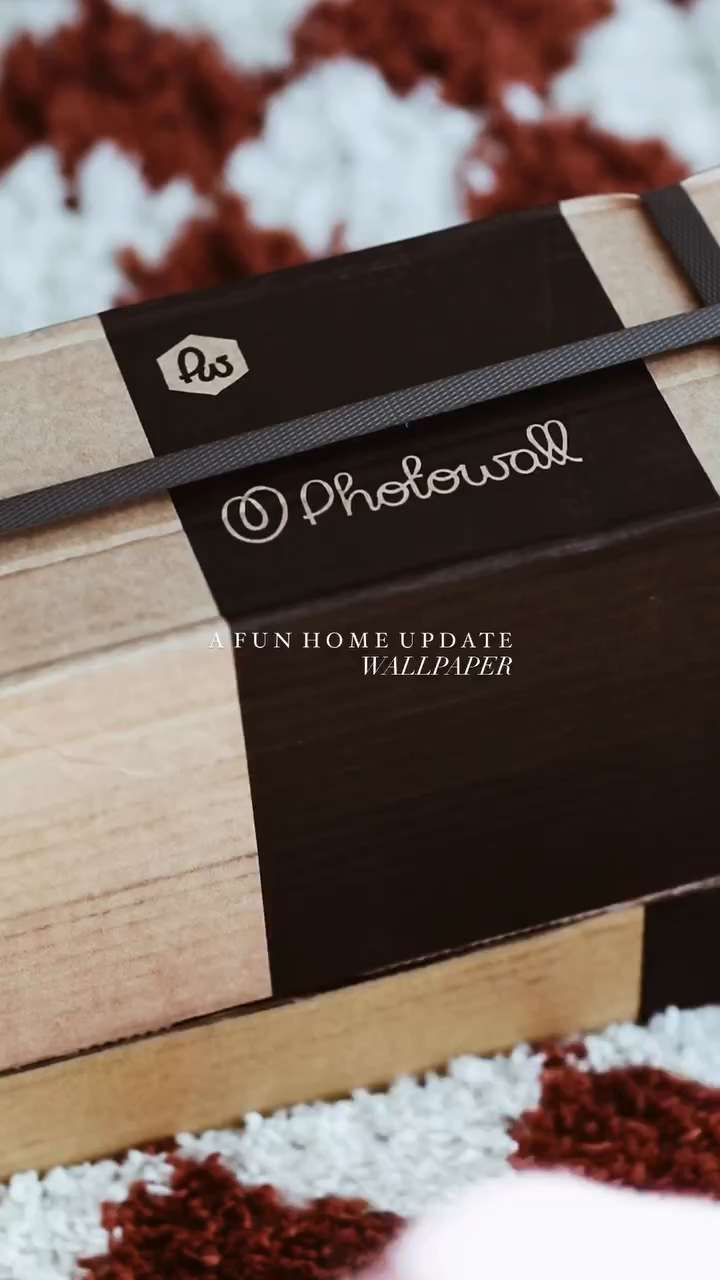 Close-up of a Photowall wallpaper package with a brown and tan design.