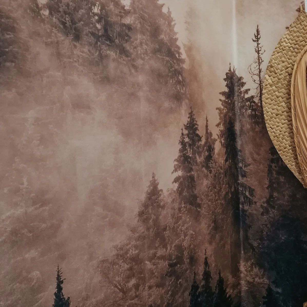 Misty forest wallpaper with woven wall decor.