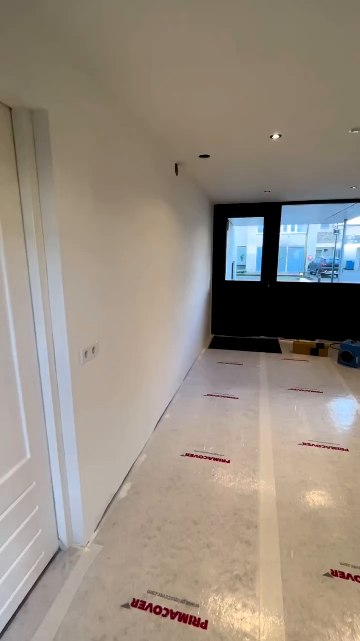 Interior view of a room with white walls and PrimaCover floor protection.