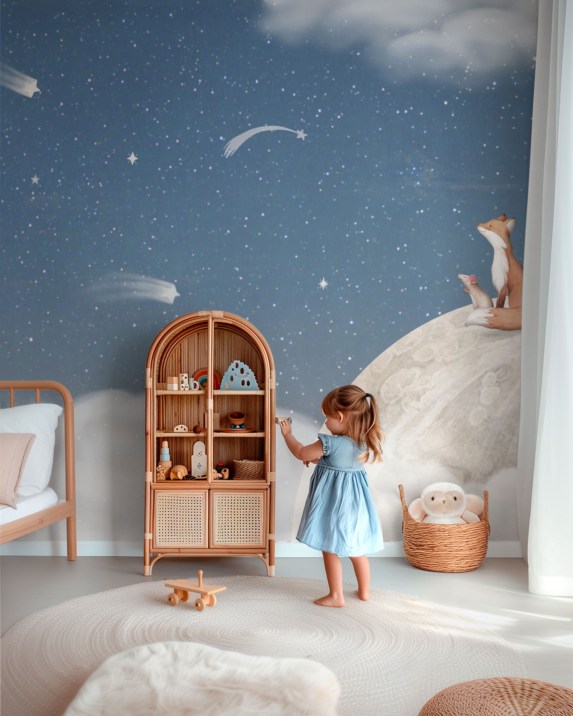 Child playing in a nursery with a rattan shelf, star wallpaper, and woodland themed decor.