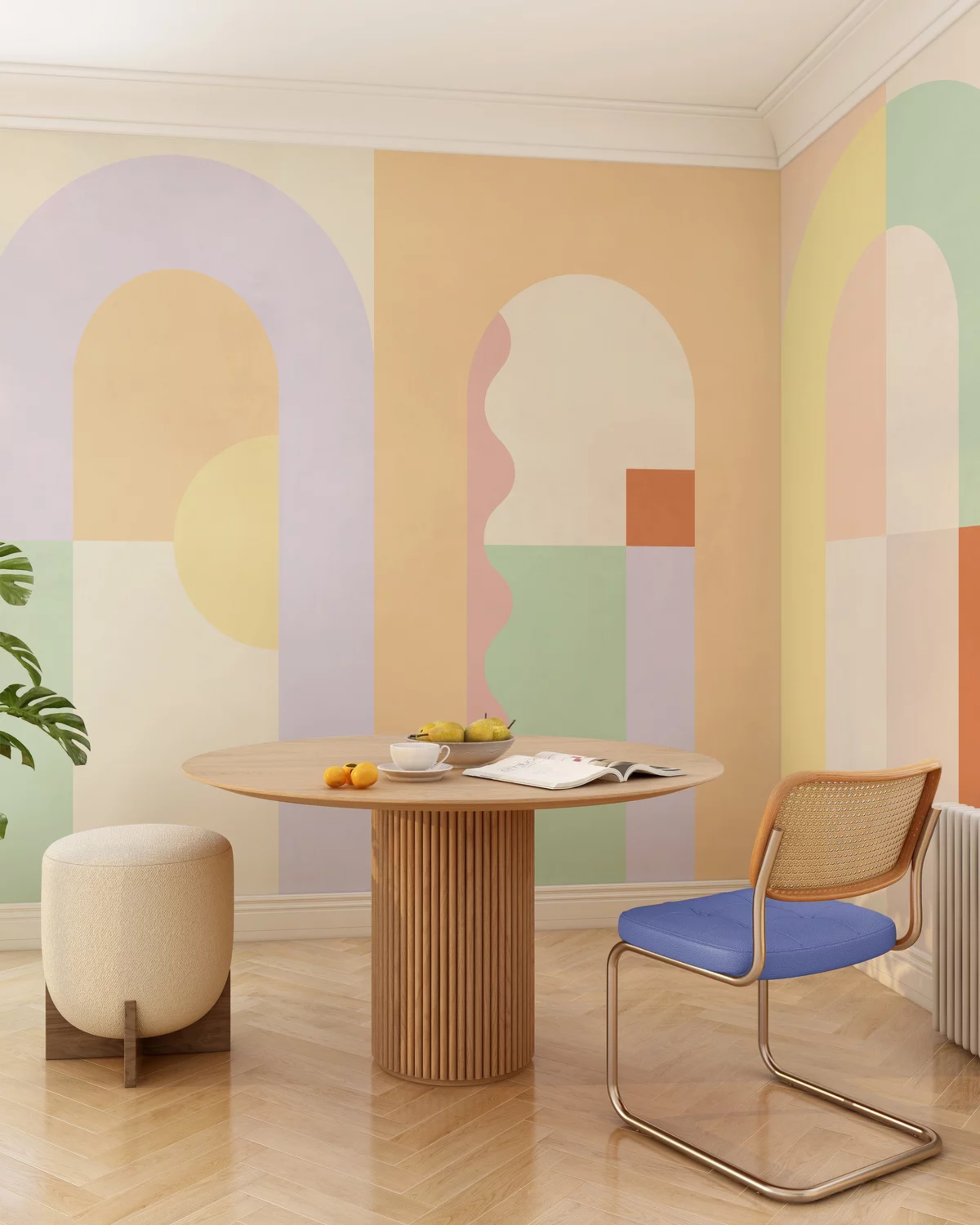 Interior with round table, blue chair, and colorful geometric wall art.
