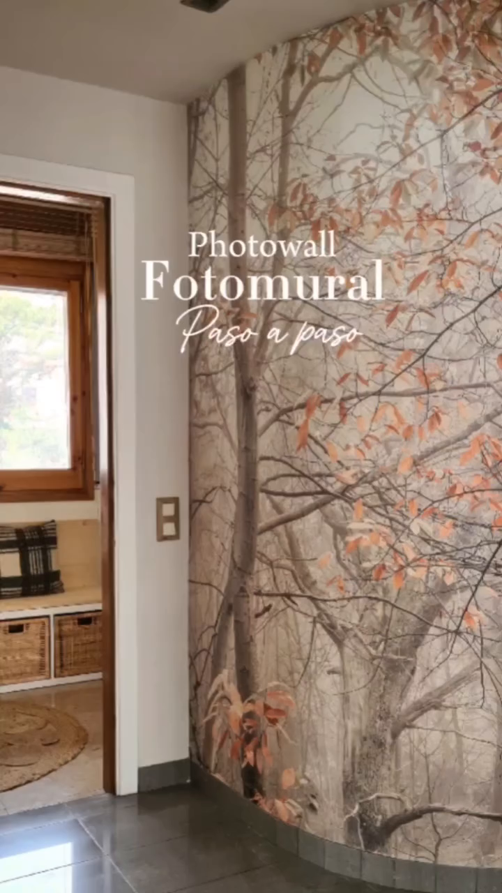 Hallway with a forest-themed Photowall mural and a glimpse into a cozy room.