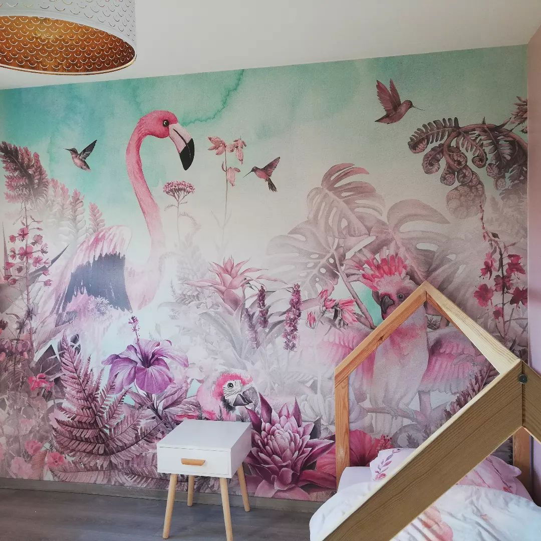 Child's bedroom with tropical wallpaper featuring flamingos, parrots, and flowers.