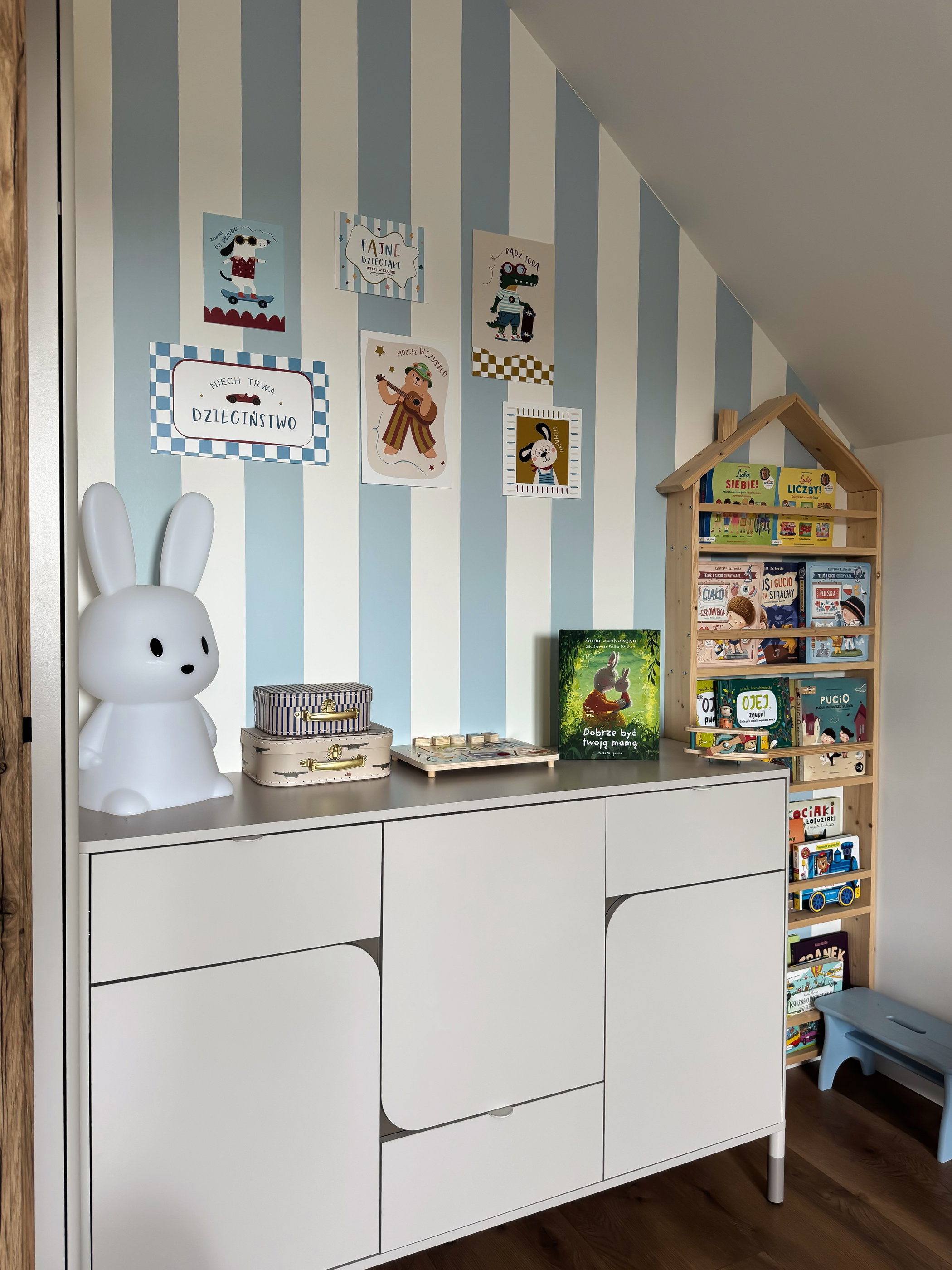 Cute white bunny lamp sits on a dresser next to stacked decorative boxes.