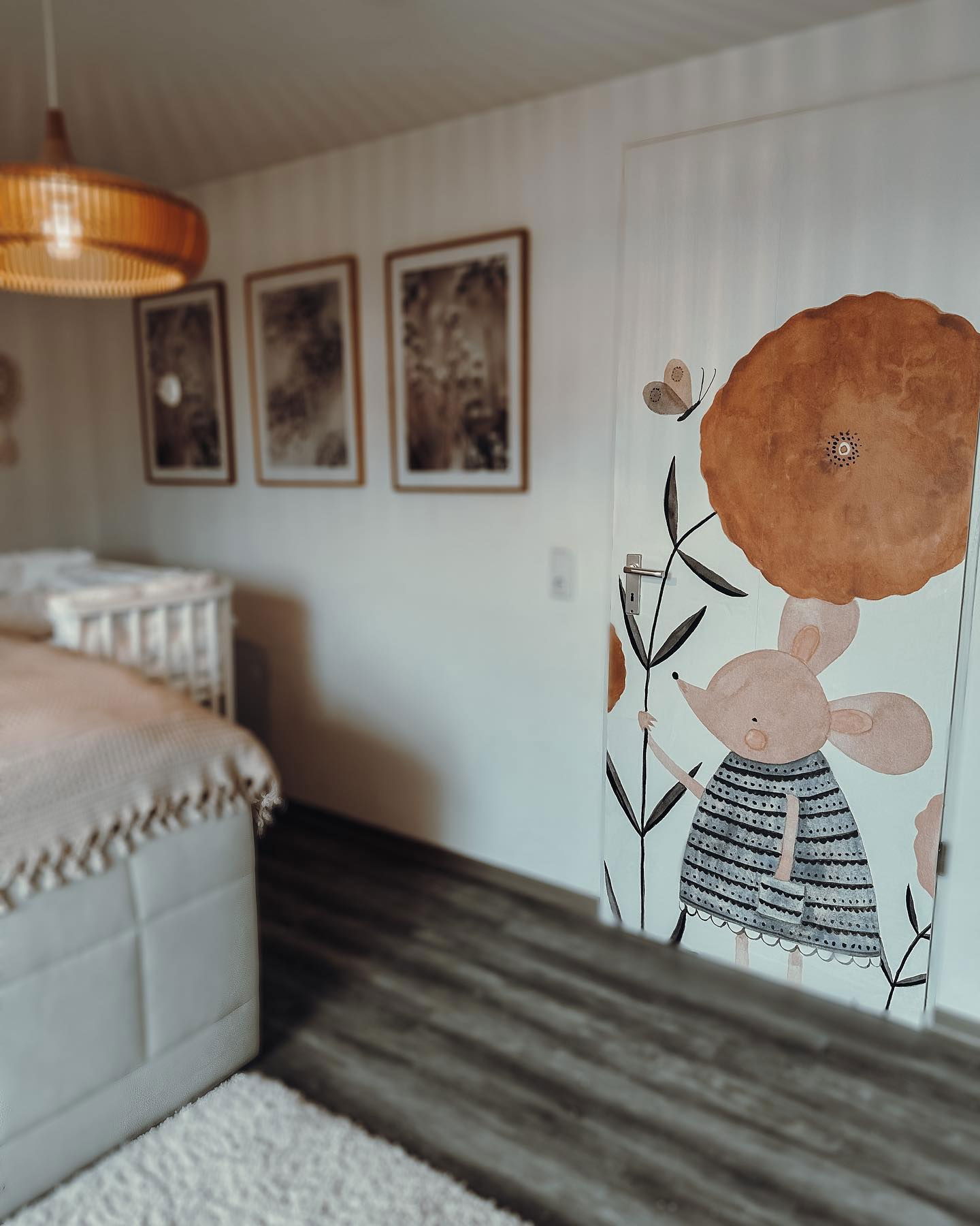 Bedroom with door decal of mouse, flower, and butterfly.