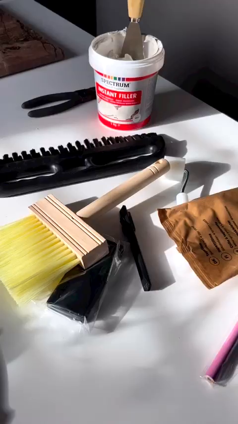Spectrum Instant Filler with tools on a white surface.