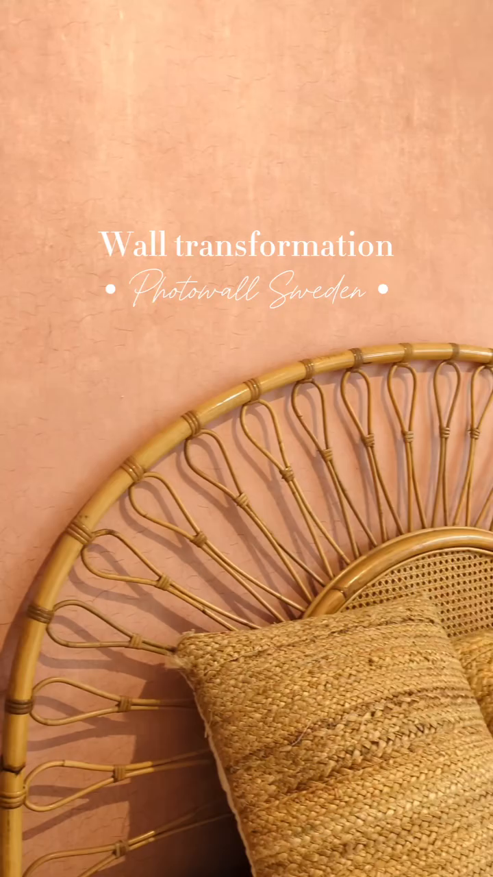 Close-up of a rattan headboard with a woven pillow against a textured pink wall. "Wall transformation - Photowall Sweden" text overlay.