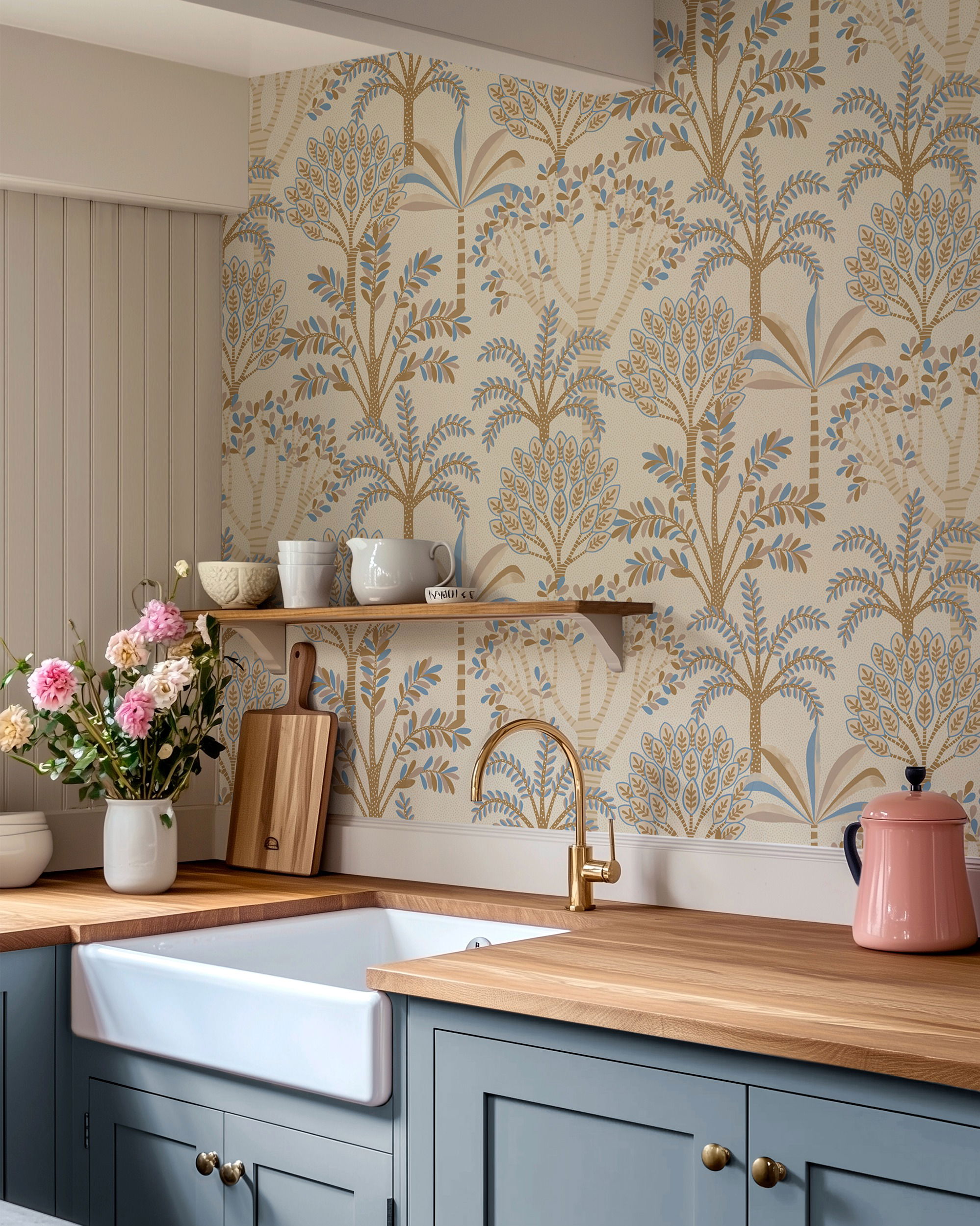 Kitchen with blue cabinets, wood countertop, white farmhouse sink, and tree-patterned wallpaper.