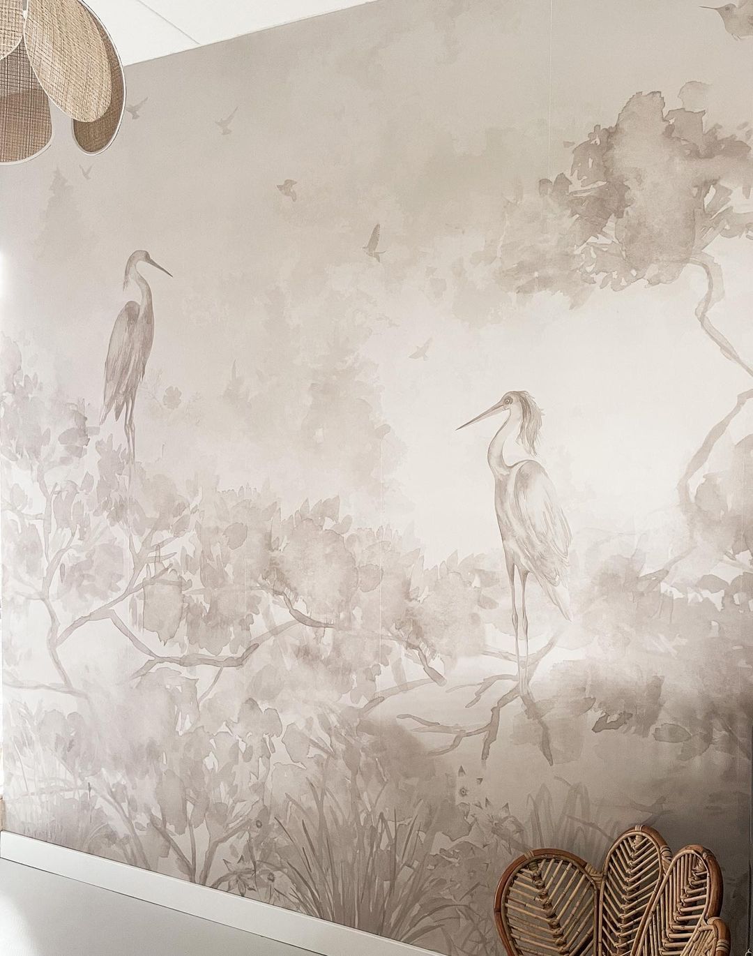 Watercolor-style wallpaper featuring herons, trees, and birds in neutral tones.