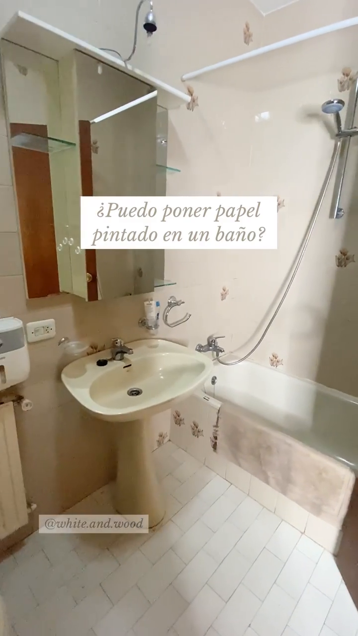 Bathroom with pedestal sink, tub, and floral wallpaper. Text asks, "Can I put wallpaper in a bathroom?"