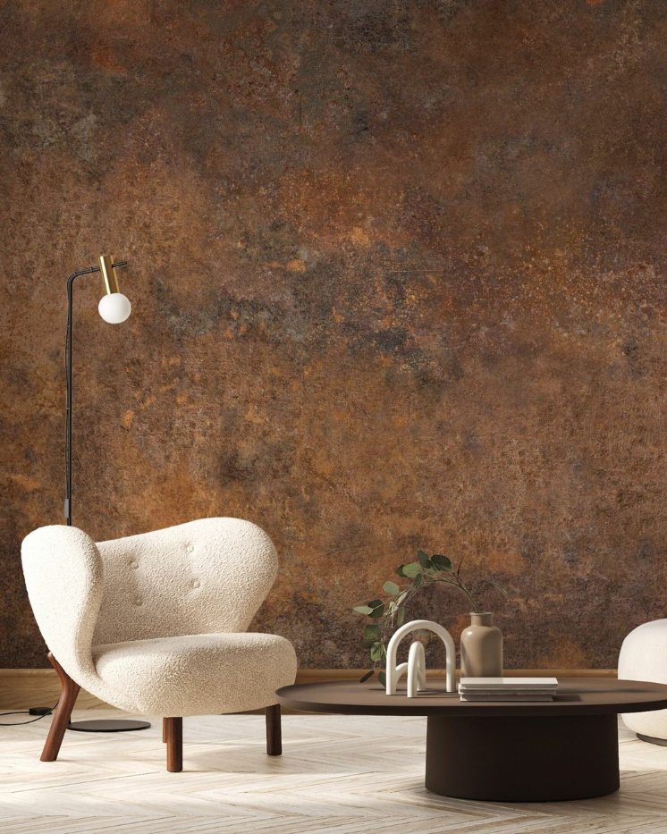 Living room with rust-colored wallpaper, white chair, and dark brown coffee table.