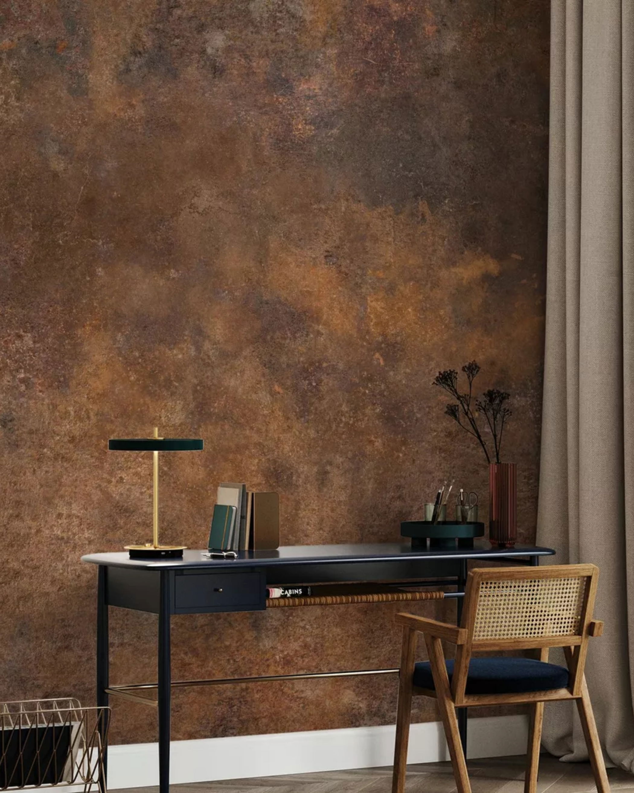 Home office setup with desk, chair, lamp, and textured brown wallpaper.