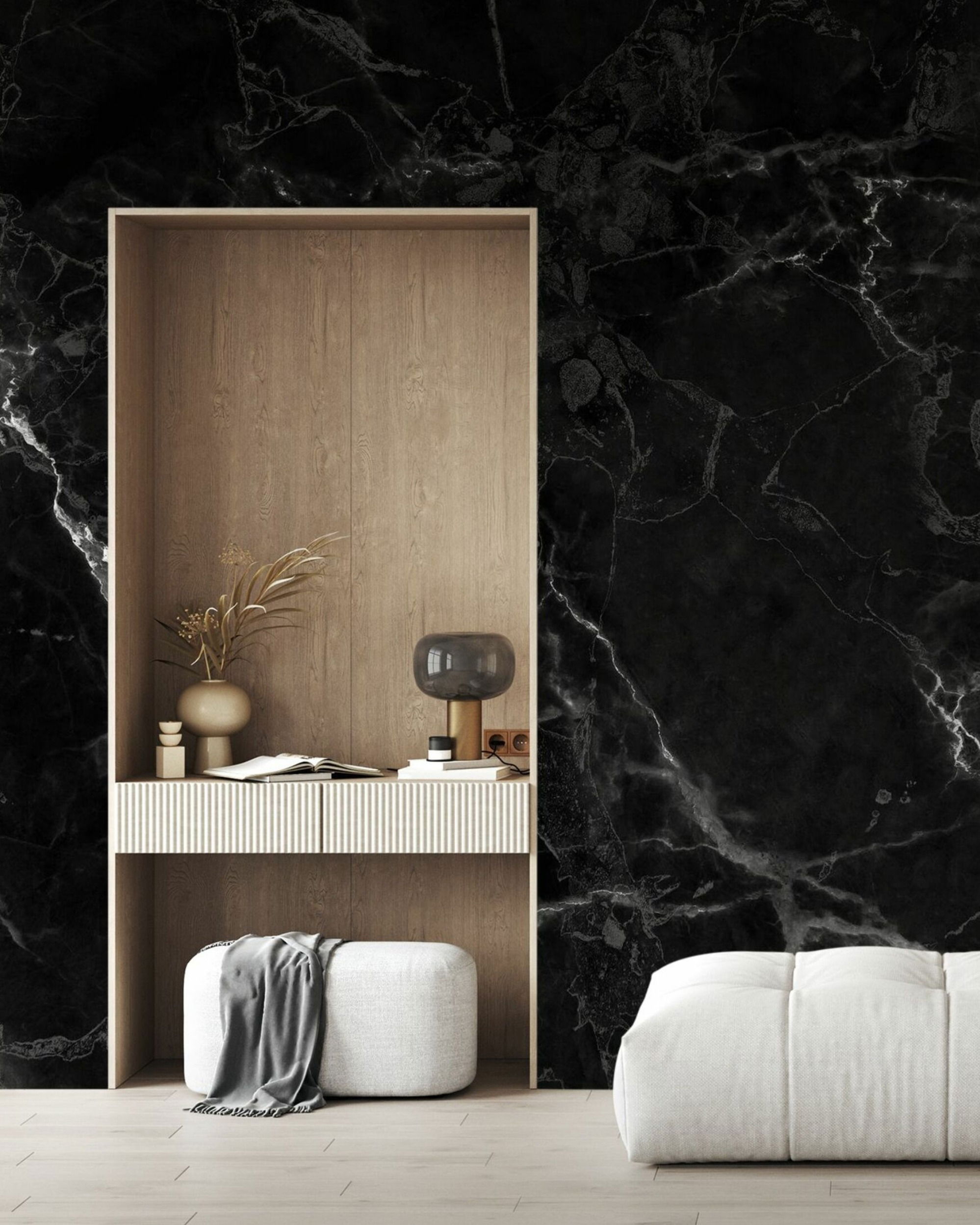 Interior with black marble wall, built-in desk, decor, and white ottoman.