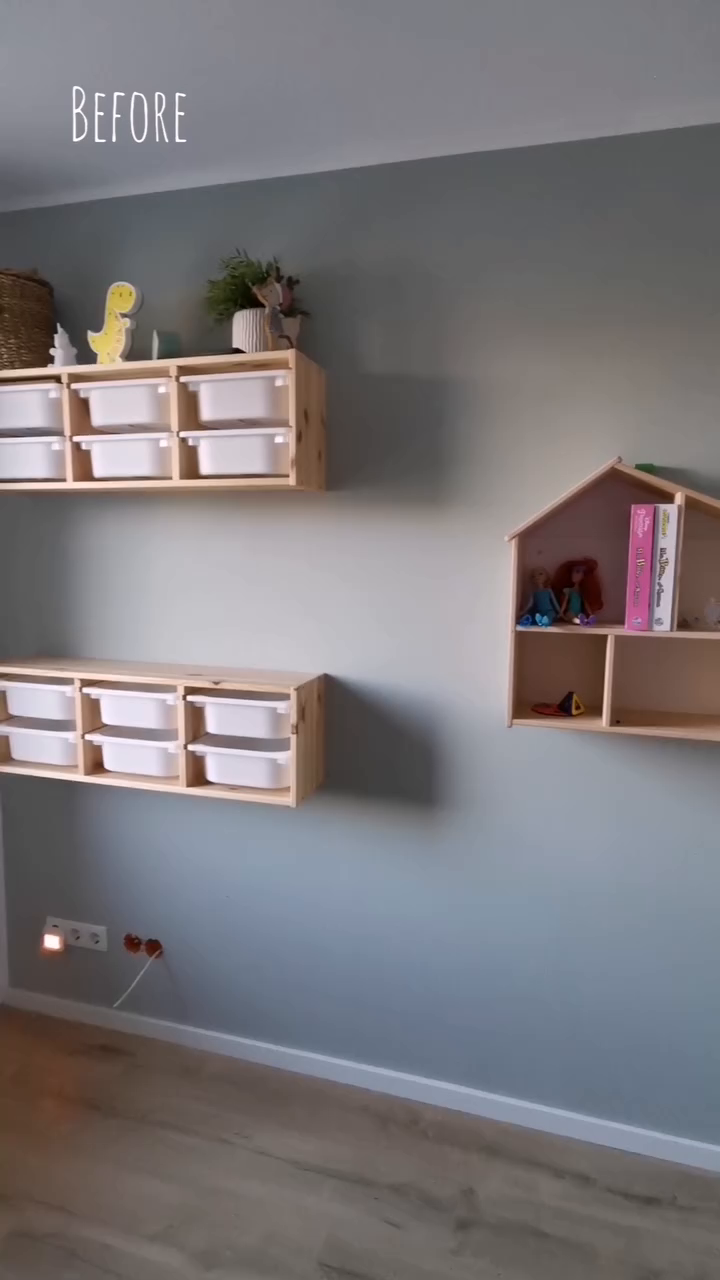 A "before" shot of a playroom with wooden shelves and white storage bins.
