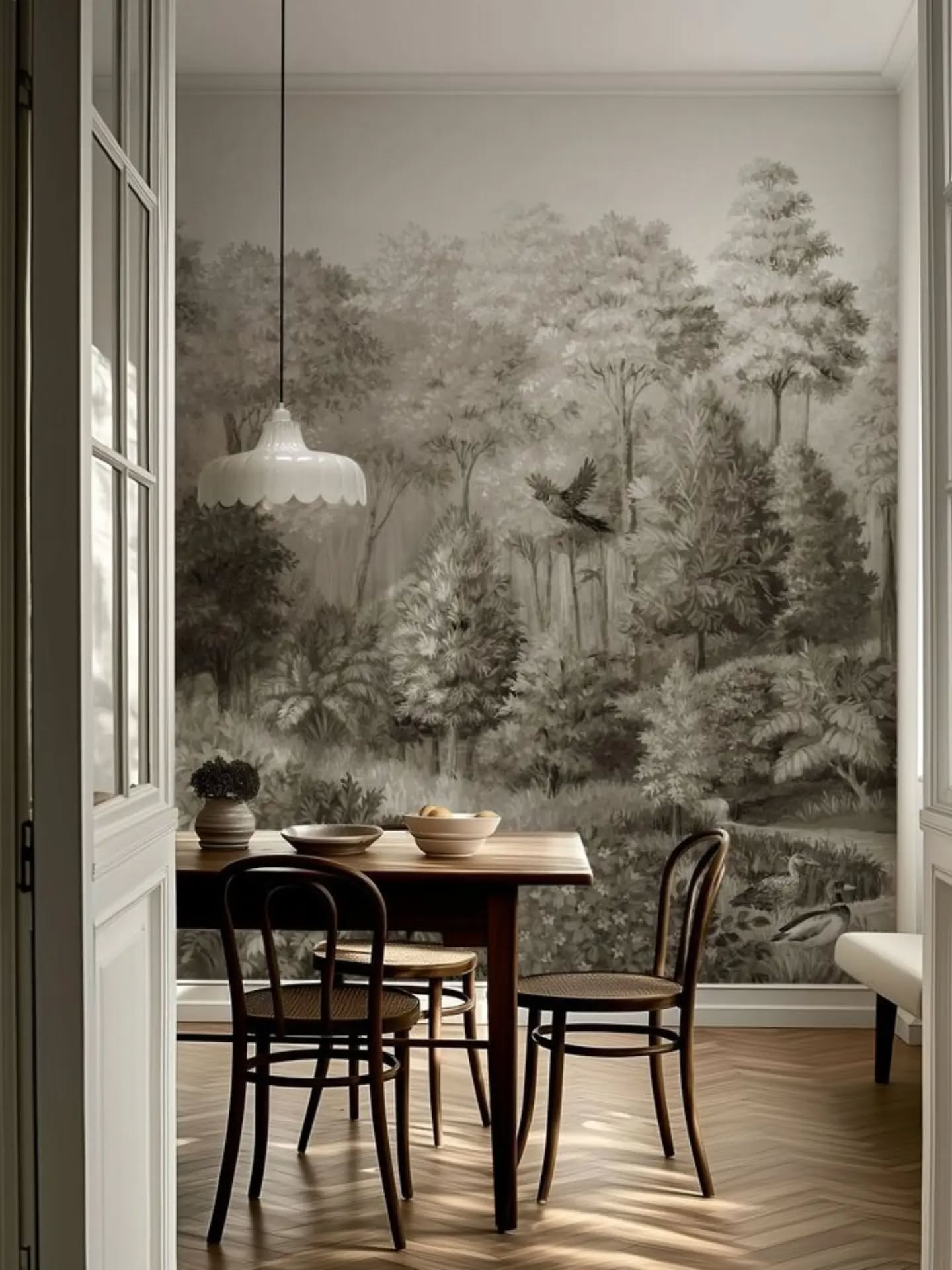 Dining room with a forest mural, wooden table, and chairs.